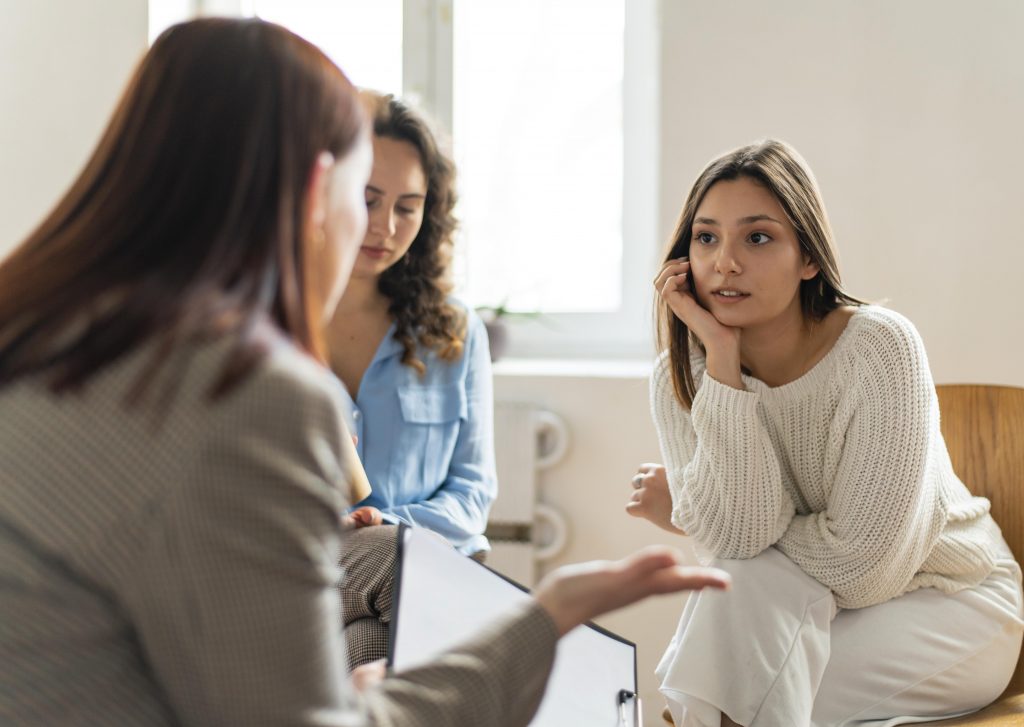 A group of young women discussing the Up to Me implementation.